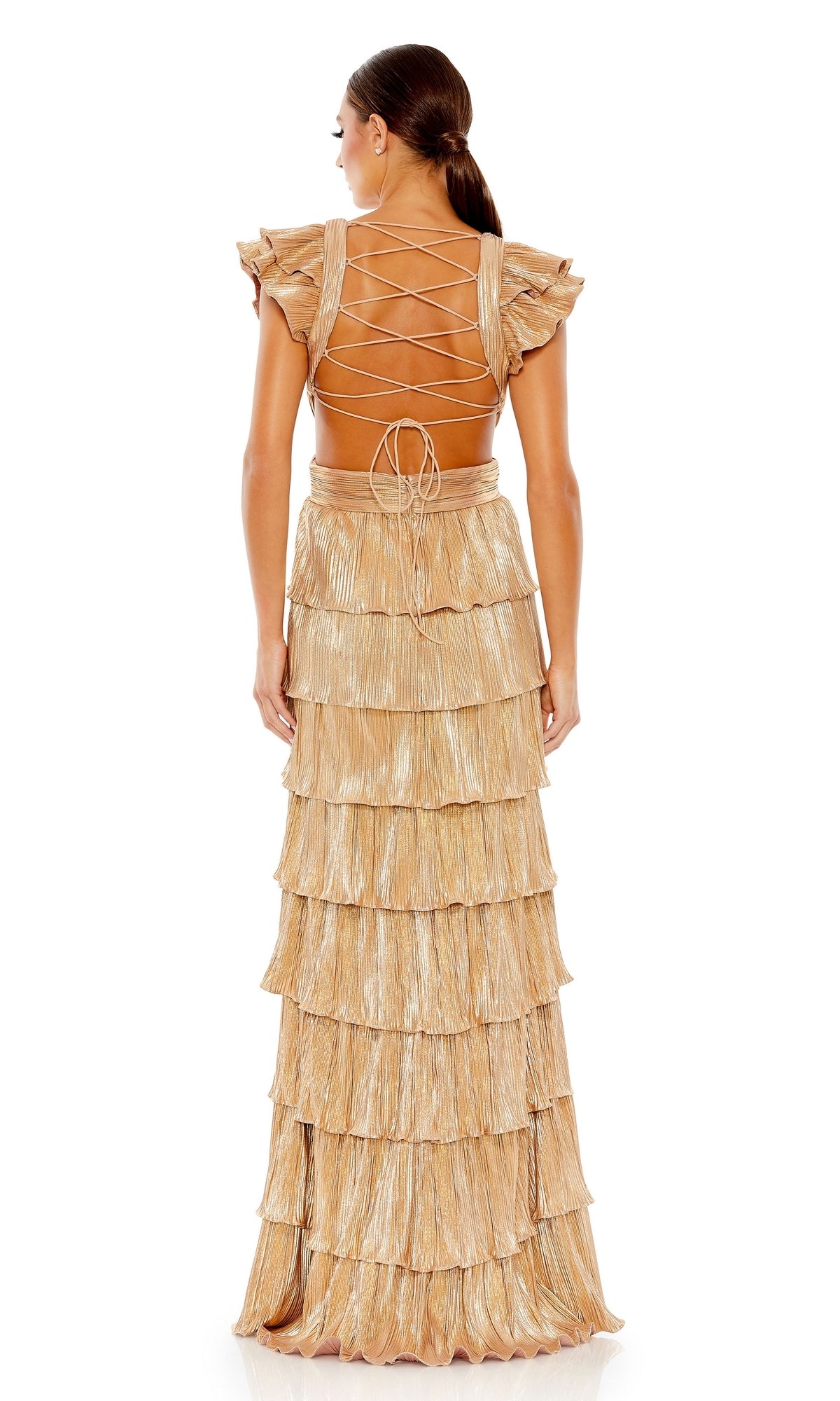 A woman stands facing away in the Mac Duggal Open-Back Tiered Formal Dress 26740, featuring gold pleated tiers, flutter sleeves, and a lace-up open back.